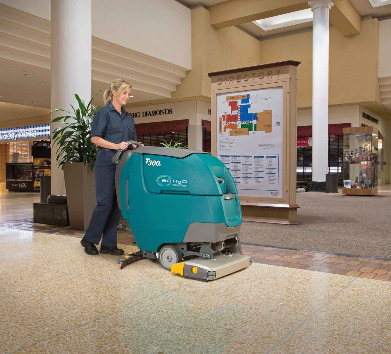 T300 Walk-Behind Scrubber scrubbing a mall floor